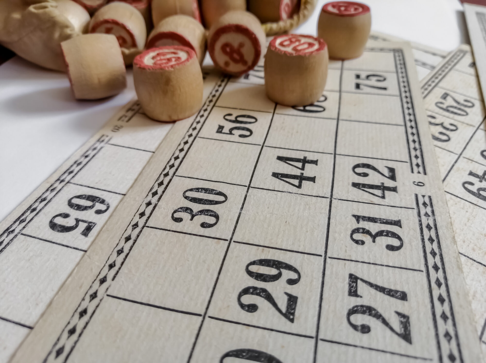 Board game lotto on a white background. Games for the whole family. Cards and barrels for playing lotto.